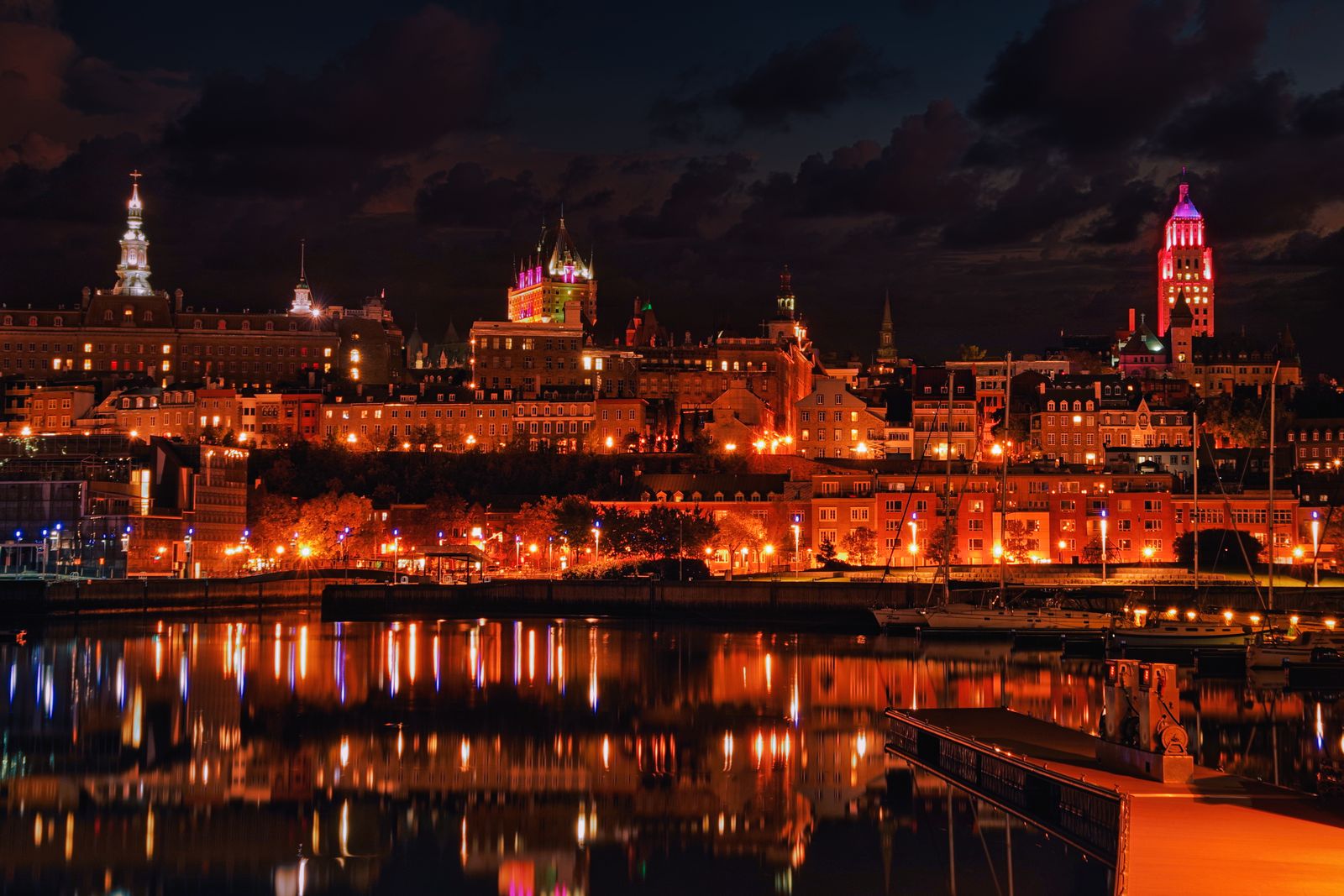 The Quebec City skyline reflecting on the St. Lawrence River at night, host city of the 2027 NAYEN conference